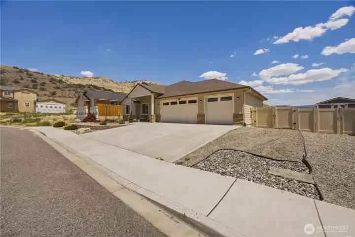 Oversized 3 car garage and side yard for RV/ Boat.