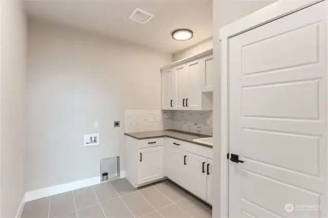 Utility room features lots of storage.