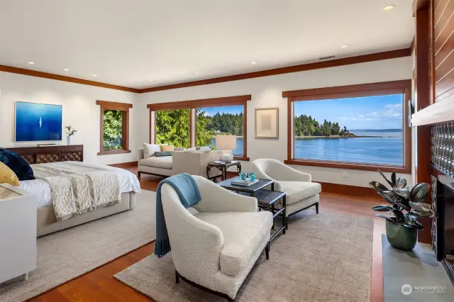 The upper level offers a luxurious primary suite with water vistas and a fireplace.