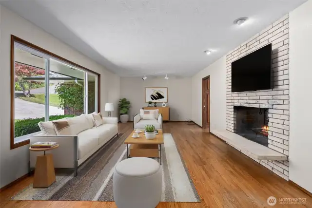 Spacious Living Room with pass-thru fireplace to Dining Room. Virtually Staged.