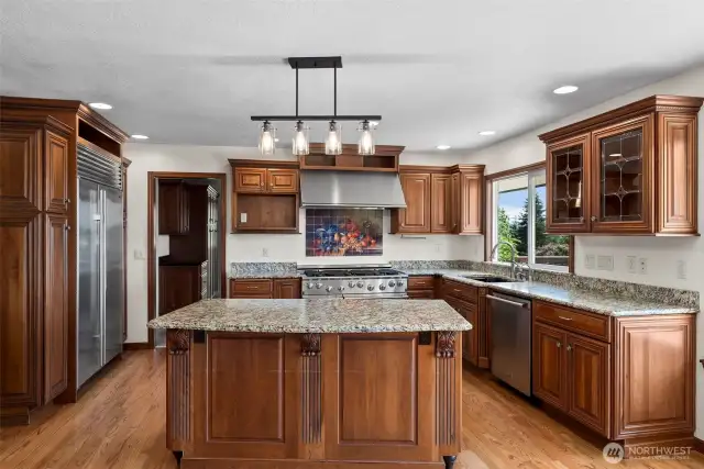 Fabulous gourmet kitchen with granite counters and luxurious custom cabinets...