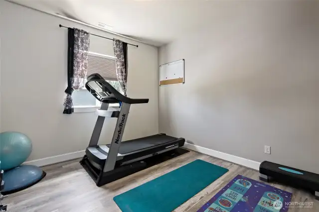 Fourth Bedroom has LVP flooring, currently used as a gym space.