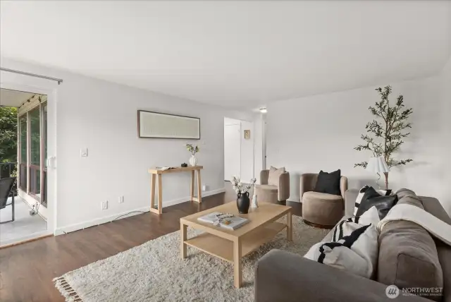 Living room with woodburning fireplace and territorial views over Interbay Golf Course and Queen Anne Hill.