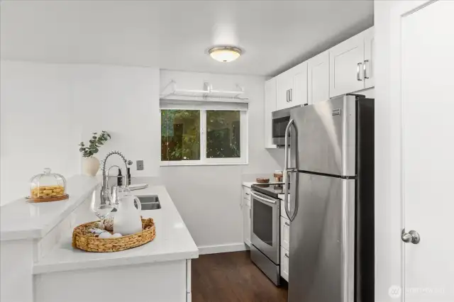 Kitchen with stainless steel appliances and large pantry.