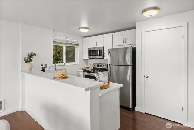 Kitchen with stainless steel appliances and large pantry.
