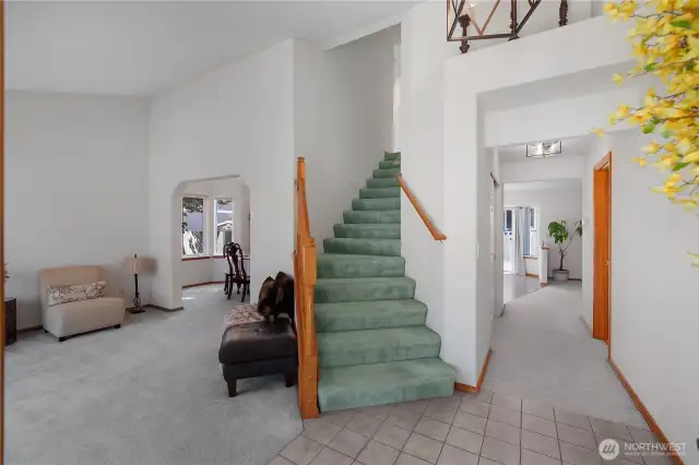 View from entry. Living Room on left, hallway straight ahead to Family Room and Kitchen area. Doorway on right to bathroom/powder room.