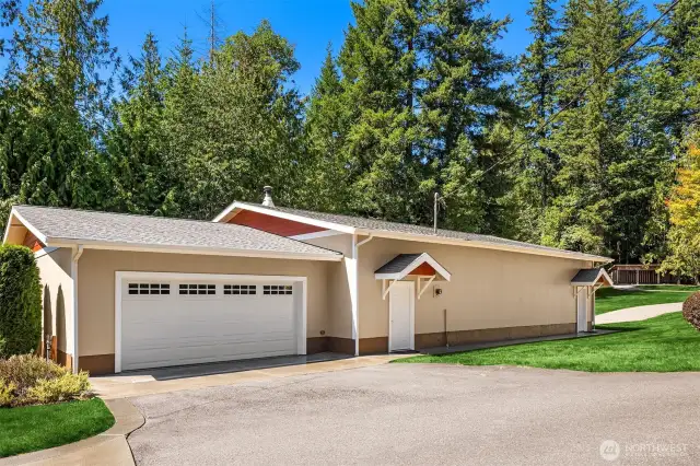 Detached garage has another garage door on the south side of the building with a carport in back.