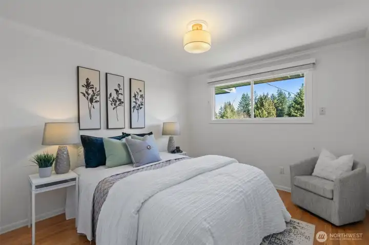 Third bedroom with a queen bed offers plenty of space for a side table and dresser.