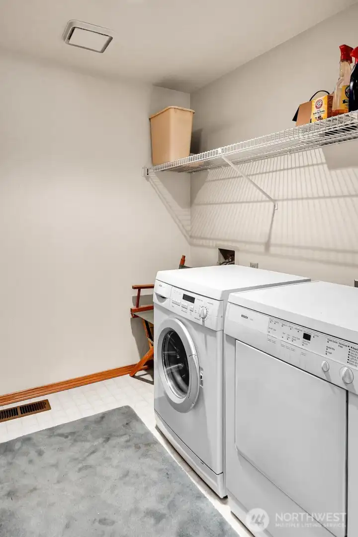 This full-sized laundry room is located between the entry hall and your huge 2-car garage (with workbench) which provides even more storage and project space.