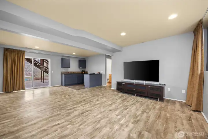 Downstairs great room and bar with slider to patio.