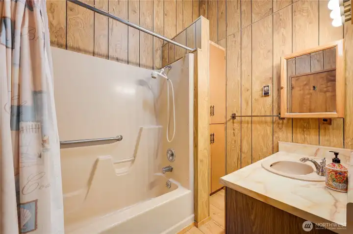 The full bathroom in the primary bedroom on the main level awaits your updates.
