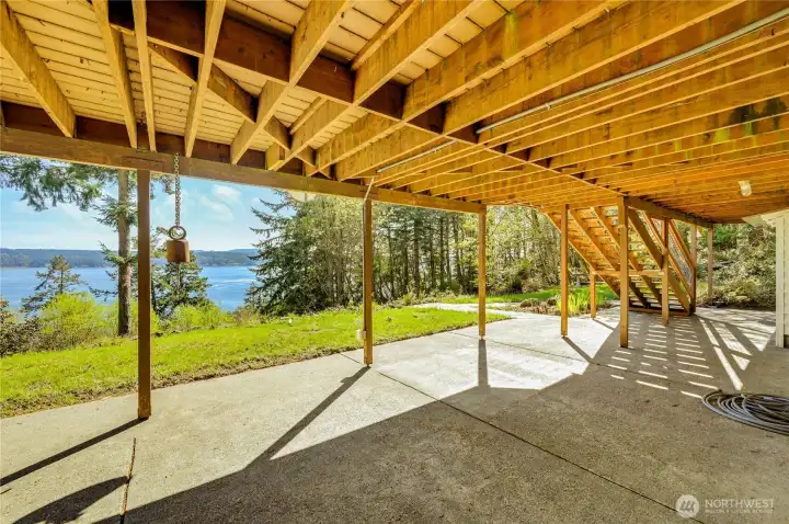 The lower level living space has a double sliding door to this spacious patio with water views. Room for a hot tub; hammock, sitting areas or whatever you want.