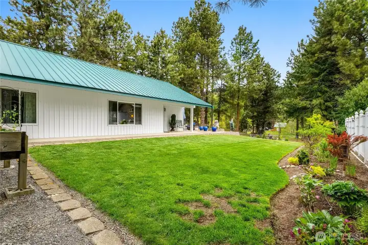 Main door to home with garden and yard view