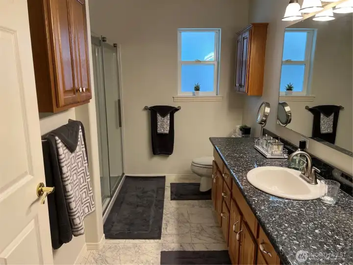 Primary bathroom with vanity, mirror, and storage