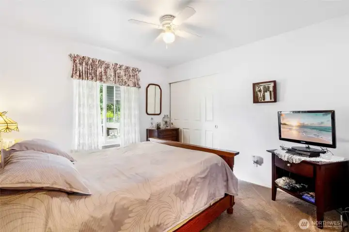 Additional bedroom with carpet flooring and natural light