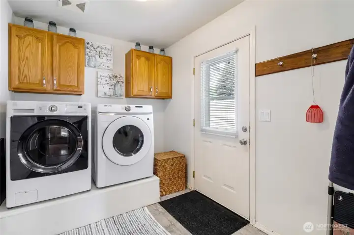 Laundry room with washer/dryer and cabinet storage