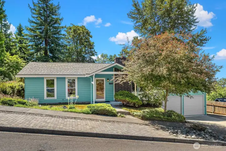 Beautifully maintained curb appeal with a professionally painted exterior, 50-year roof installed in 2024, triple-pane windows, and mature landscaping.