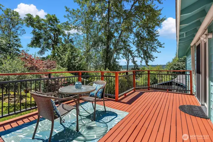 A spacious deck extends the living area outdoors, offering room to dine, relax, and enjoy the leafy greenbelt setting and territorial outlook.