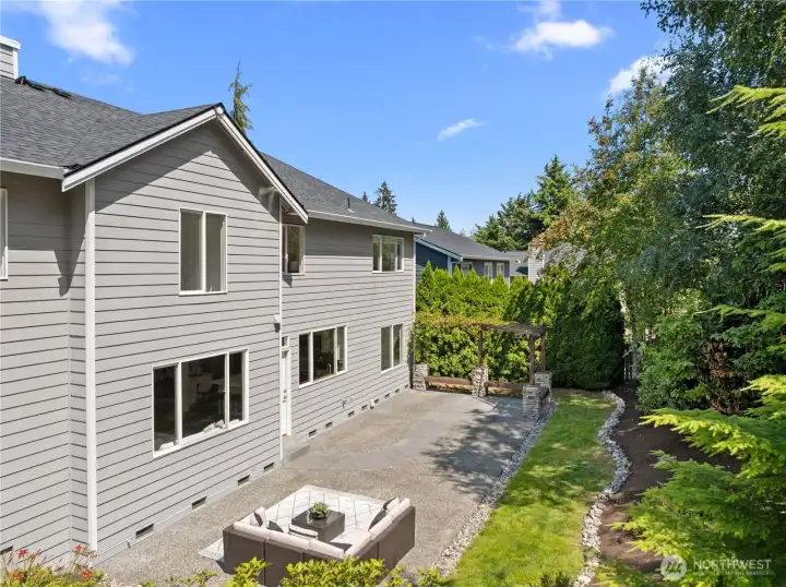 Fully fenced backyard with pergola and huge patio.