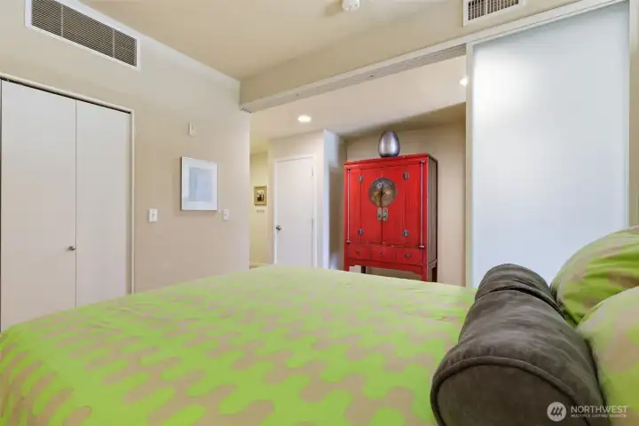Bedroom with partially closed sliding door.