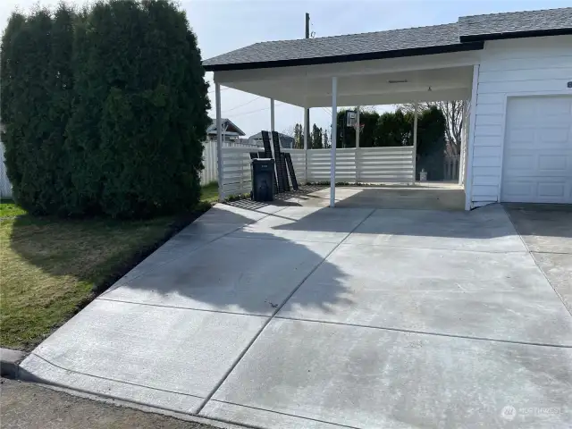 New cement driveway leading to the carport.