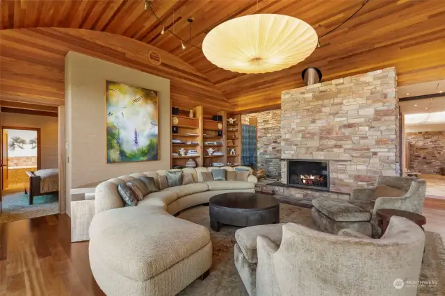 Living room with acoustically enhancing barrel ceiling.  Primary bedroom to the left.