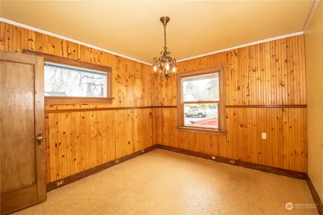 Primary bedroom with warm wood paneling