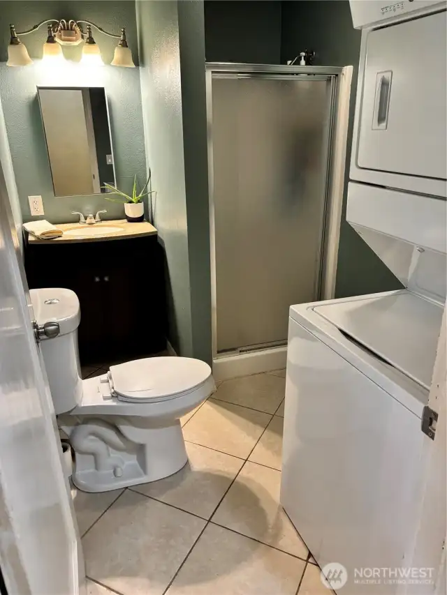 3/4 bath with stacking washer and dryer.