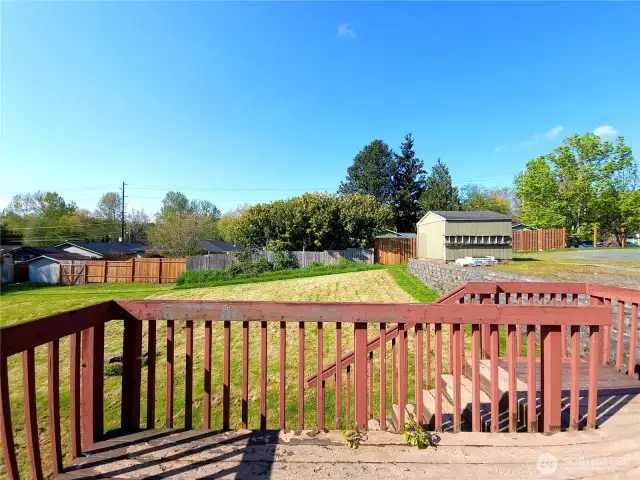 Deck off of kitchen overlooking large back yard