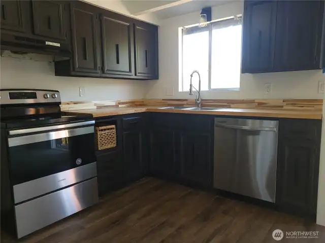 Kitchen with new butcher block counters, flooring, & sink!