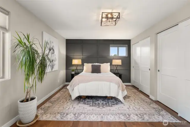 Feature wall in the primary bedroom in only another example of the classic decorator touches. Warming up the room and setting it apart. Both closets have custom shelving to maximize use.