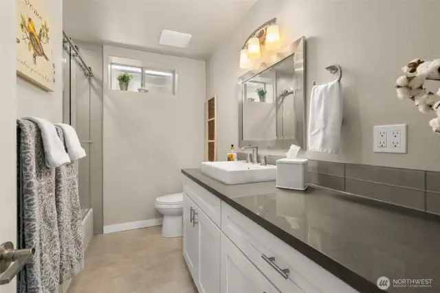 No skimping on the downstairs bathroom. Love the designer tiles and colors.