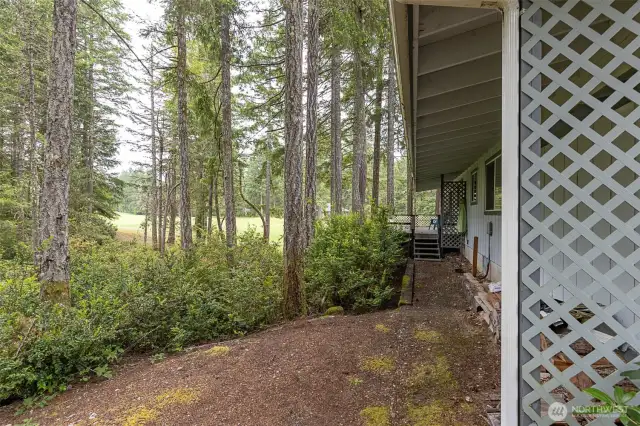 side yard with steps to the deck