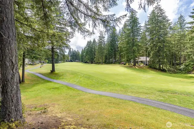 view from the yard to the 11th hole fairway and green.