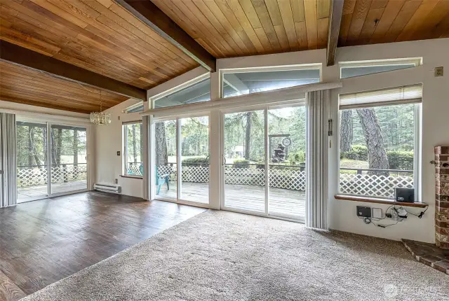 great view to the golf course.  Dining room is the laminate flooring area. Check out the windows, exposed beams and wood plank ceiling!