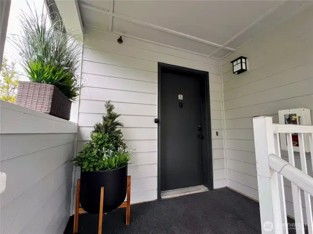 Welcome entry, covered with outdoor carpeting and inviting