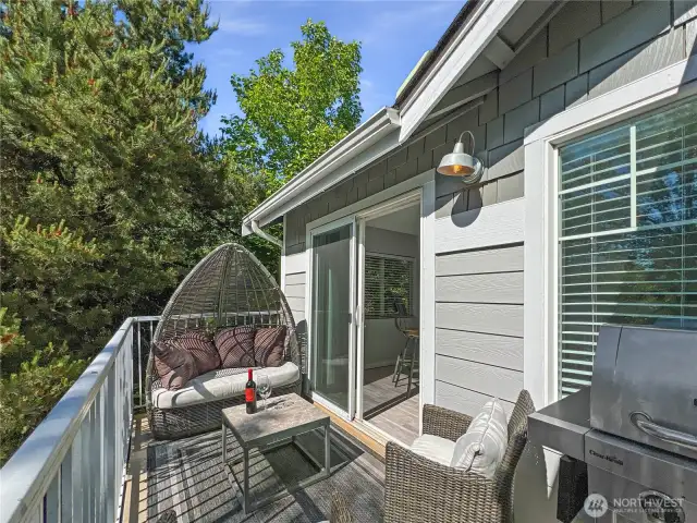 Patio is bathed in natural light and is tucked away behind mature landscaping.