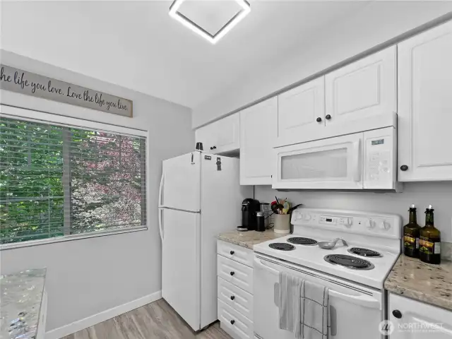 The kitchen window offers mature landscaping and a sense of seclusion.