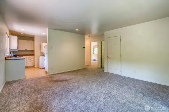 Upstairs living, kitchen, and view of hall into bedrooms