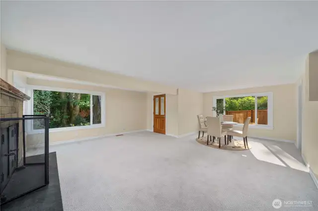 Large dining room with fireplace and extra bonus room. And a door leading outside.