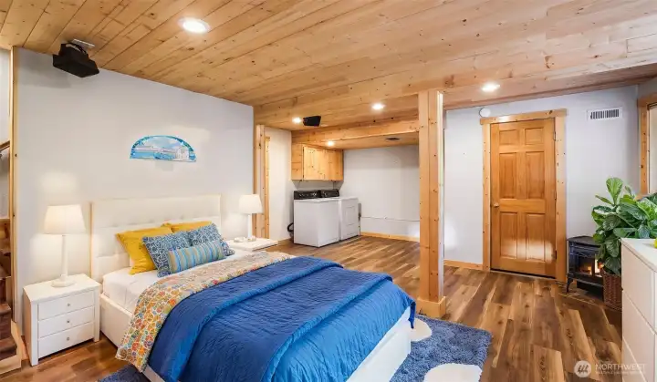 The finished basement with Lopi gas stove is perfect for a bedroom or recreation room. (room is virtually staged)