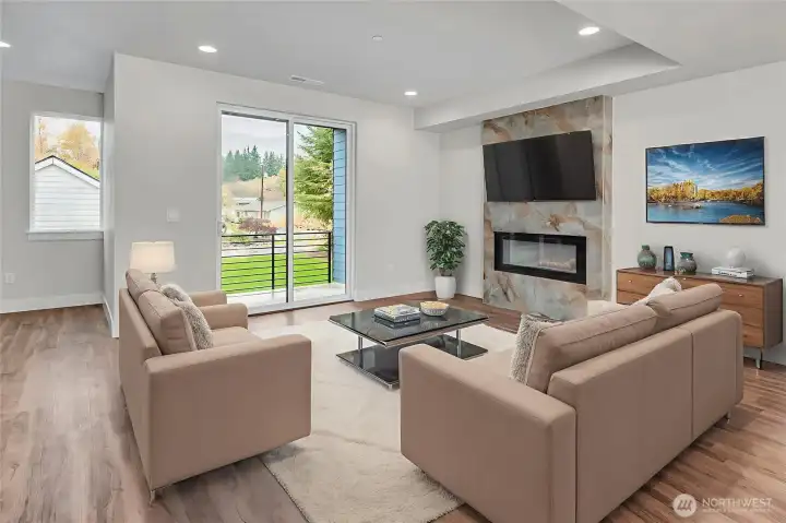 Welcoming living area on main level with electric fireplace. Virtually staged.