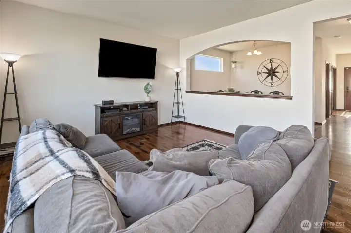 A spacious living room with a pass-through to the dining room and quick kitchen access—built for relaxing nights and effortless hosting.