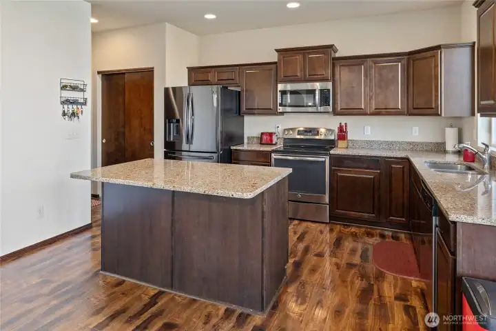 Because every party gravitates to the kitchen! With newer stainless appliances, granite counters, tons of storage (hello, pantry & under-stair closet), and room for bar stools and a breakfast table, this open-concept space connects