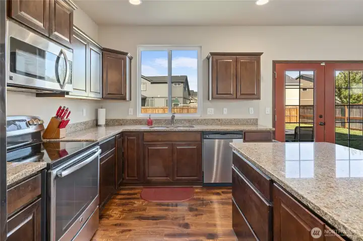 Plenty of counter space and cabinetry, plus a window peeking out to the back yard makes for enjoyable time in the kitchen