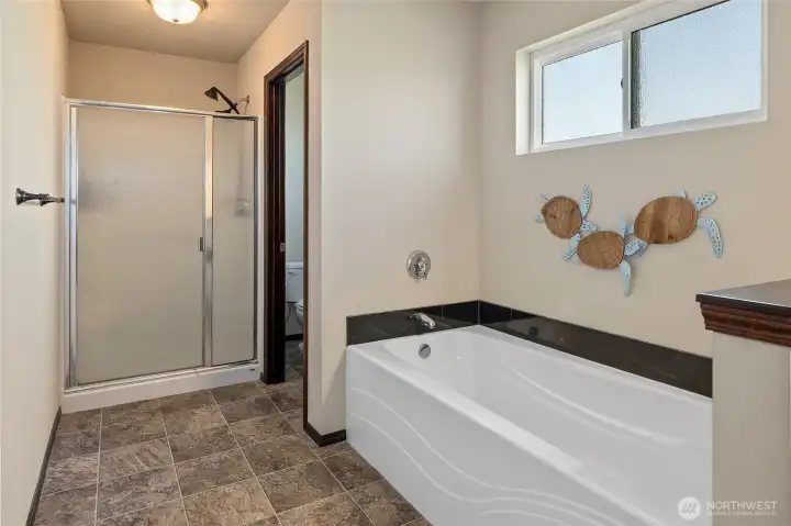 Separate soaking tub and shower in the primary bathroom