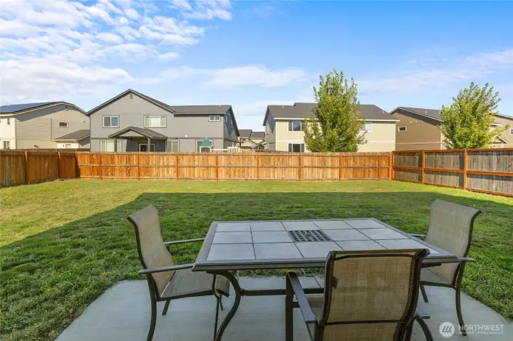 A large, flat, partially fenced yard with a concrete patio right off the kitchen— ready for games, gardens, or gatherings. Bonus: irrigation system keeps things green (just $45.50/month, April–October)