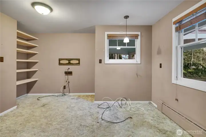 Extra den office just off the entry hall with built-in shelving!