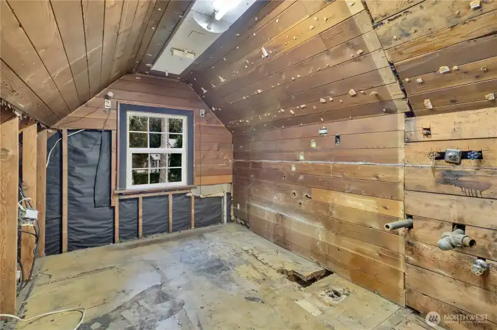 This unfinished area upstairs appears to have plumbing for another bath.