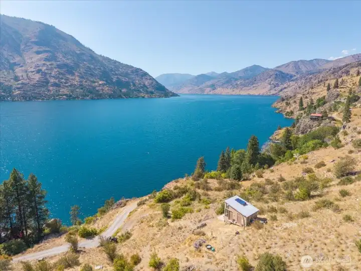 View of cabin overlookign the lake and mountains